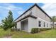 Exterior view of the back of the home with a covered patio and well-maintained landscaping at 8305 Crescent Oaks Dr, New Port Richey, FL 34655