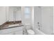 Bathroom featuring a granite-topped vanity and a shower and bathtub combination at 8305 Crescent Oaks Dr, New Port Richey, FL 34655