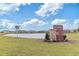 Welcoming entrance to the residential community by a pond with lush green surroundings at 8305 Crescent Oaks Dr, New Port Richey, FL 34655