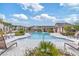 Resort-style community pool with lounge chairs and lush landscaping at 8305 Crescent Oaks Dr, New Port Richey, FL 34655