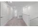 Upstairs hallway with carpet and white walls with multiple doorways to other rooms at 8305 Crescent Oaks Dr, New Port Richey, FL 34655