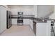 Well-equipped kitchen with stainless steel appliances and a bar-style counter, perfect for dining at 8305 Crescent Oaks Dr, New Port Richey, FL 34655