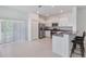 Bright kitchen featuring stainless steel appliances and a breakfast bar for casual dining at 8305 Crescent Oaks Dr, New Port Richey, FL 34655