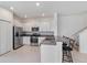 The contemporary kitchen boasts stainless steel appliances and a bar seating area at 8305 Crescent Oaks Dr, New Port Richey, FL 34655