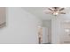 Bright living room with ceiling fan, white walls, and nearby doorways at 8305 Crescent Oaks Dr, New Port Richey, FL 34655