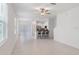 Bright and airy open-concept living space featuring large windows and sleek tile flooring at 8305 Crescent Oaks Dr, New Port Richey, FL 34655