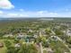 Aerial view of the neighborhood showcasing the lush landscape and waterway at 8340 Saint Marks Ct, Hudson, FL 34667