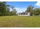 Large backyard featuring ample grass and mature trees at 8340 Saint Marks Ct, Hudson, FL 34667