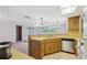 Bright kitchen with a double sink, modern appliances, and a pass-through to the living area at 8340 Saint Marks Ct, Hudson, FL 34667