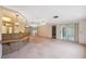 Open concept living area with a partial kitchen view, sliding doors, and plenty of natural light at 8340 Saint Marks Ct, Hudson, FL 34667
