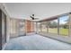Enclosed patio with fan, multiple windows and entry door at 8340 Saint Marks Ct, Hudson, FL 34667