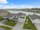 Stunning aerial view showcases the property's location on a tranquil lake with beautifully landscaped surroundings at 8938 Bower Bass Cir, Wesley Chapel, FL 33545
