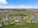 Areal view of a neighborhood featuring well-maintained lawns, water features, and modern homes at 8938 Bower Bass Cir, Wesley Chapel, FL 33545