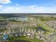 Aerial view of a well-planned community with multiple ponds and green spaces under a blue sky at 8938 Bower Bass Cir, Wesley Chapel, FL 33545