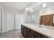 Bright bathroom boasts double vanity, large mirror, modern lighting, and neutral walls at 8938 Bower Bass Cir, Wesley Chapel, FL 33545