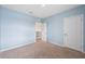 Carpeted bedroom features neutral walls, and white doors, creating a serene space at 8938 Bower Bass Cir, Wesley Chapel, FL 33545