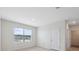 A bright bedroom with a window view and neutral carpeting at 8938 Bower Bass Cir, Wesley Chapel, FL 33545