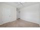 Bright bedroom features carpet, neutral paint, ceiling fan, and white doors at 8938 Bower Bass Cir, Wesley Chapel, FL 33545