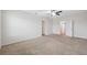 Large carpeted bedroom with ceiling fan and doorways to additional rooms at 8938 Bower Bass Cir, Wesley Chapel, FL 33545