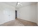 Bedroom featuring carpet floors, a ceiling fan, and a double door closet at 8938 Bower Bass Cir, Wesley Chapel, FL 33545