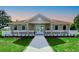 Welcoming community clubhouse featuring a covered front porch and manicured landscaping at 8938 Bower Bass Cir, Wesley Chapel, FL 33545