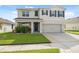 Charming two-story home with manicured lawn, lush landscaping, and a two car garage at 8938 Bower Bass Cir, Wesley Chapel, FL 33545