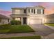 Charming two-story home boasts a well-manicured lawn and inviting covered porch, with a two-car garage and neutral paint at 8938 Bower Bass Cir, Wesley Chapel, FL 33545