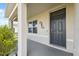 Inviting front porch features stone columns and landscaping detail at 8938 Bower Bass Cir, Wesley Chapel, FL 33545