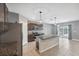 Well-lit kitchen with stainless steel appliances, granite countertops, large island, and a tile backsplash at 8938 Bower Bass Cir, Wesley Chapel, FL 33545
