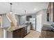 This kitchen has an island with a sink, granite countertops, tile flooring, and stainless steel appliances at 8938 Bower Bass Cir, Wesley Chapel, FL 33545