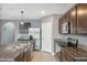 Kitchen has stainless steel appliances, granite countertops, and a large island with a sink and tile backsplash at 8938 Bower Bass Cir, Wesley Chapel, FL 33545