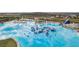 Aerial view of stunning community lagoon and recreational waterpark at 8938 Bower Bass Cir, Wesley Chapel, FL 33545