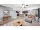 Open concept living room has a stairway, kitchen, dining area, and is well furnished at 8938 Bower Bass Cir, Wesley Chapel, FL 33545