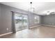 Open concept room with large sliding glass doors to a patio and a fan at 8938 Bower Bass Cir, Wesley Chapel, FL 33545