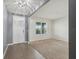 Inviting living room with neutral carpet, stylish chandelier, and natural light at 8938 Bower Bass Cir, Wesley Chapel, FL 33545