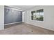 Neutral living room features carpet and tile flooring, large window and easy access to front door at 8938 Bower Bass Cir, Wesley Chapel, FL 33545