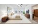 Stylishly decorated main bedroom featuring a king bed, modern furniture, and abundant natural light at 8938 Bower Bass Cir, Wesley Chapel, FL 33545
