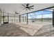 Spacious screened-in patio with brick flooring and ceiling fans offers outdoor living space at 8938 Bower Bass Cir, Wesley Chapel, FL 33545