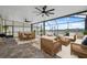 Screened-in patio is furnished with dining and lounging furniture, ideal for entertaining at 8938 Bower Bass Cir, Wesley Chapel, FL 33545