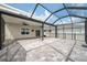 Enclosed patio with ceiling fans provides a comfortable transition to the backyard space at 8938 Bower Bass Cir, Wesley Chapel, FL 33545
