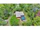 Aerial view of the home, screened-in pool, and surrounding greenery at 9130 Madrid Rd, Weeki Wachee, FL 34613