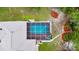 Aerial view showcasing a beautiful pool and screened-in enclosure adjacent to the residence at 9130 Madrid Rd, Weeki Wachee, FL 34613