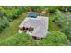 Aerial shot of the property showcasing the house, screened pool, and surrounding greenery at 9130 Madrid Rd, Weeki Wachee, FL 34613