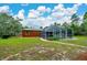 Home backyard showcasing a screened-in pool enclosure at 9130 Madrid Rd, Weeki Wachee, FL 34613
