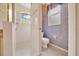 Bathroom features an enclosed shower with mosaic tile, toilet, and small window at 9130 Madrid Rd, Weeki Wachee, FL 34613