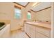 Bathroom with a white vanity, toilet, framed mirror, and decorative border at 9130 Madrid Rd, Weeki Wachee, FL 34613