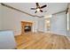 Bedroom with a fireplace, light wood floors, and ensuite bathroom at 9130 Madrid Rd, Weeki Wachee, FL 34613