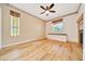 Bright Primary bedroom has wood-look floors, a ceiling fan, a fireplace and natural light at 9130 Madrid Rd, Weeki Wachee, FL 34613
