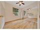 Bedroom with light wood floors, ceiling fan, lots of natural light and wall to wall mirror at 9130 Madrid Rd, Weeki Wachee, FL 34613