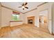 Bedroom with fireplace, light wood floors, ceiling fan and natural light at 9130 Madrid Rd, Weeki Wachee, FL 34613